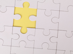 Decorative image of a jigsaw puzzle with a piece missing