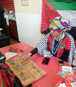 People playing a traditional game of mancala.